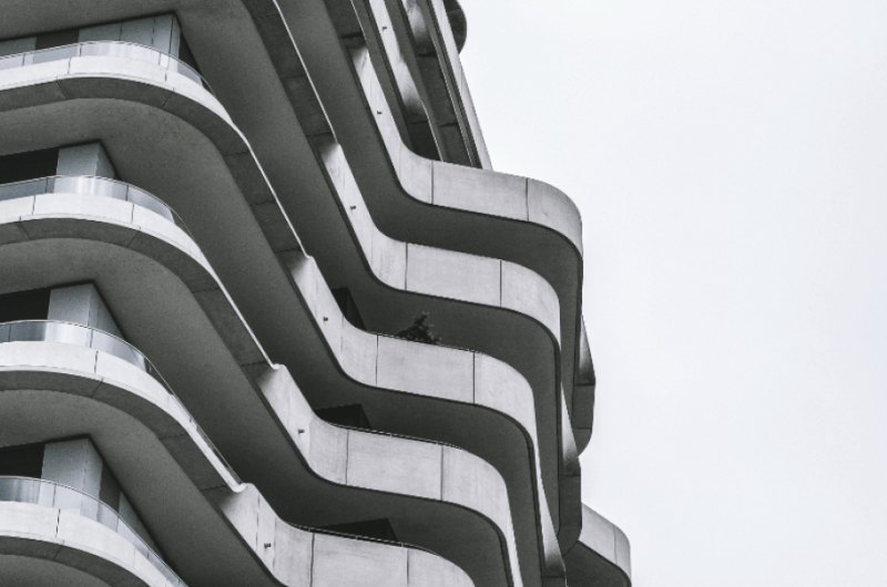 Curved Multi-Floor Building With Breezeways Under Overcast Sky