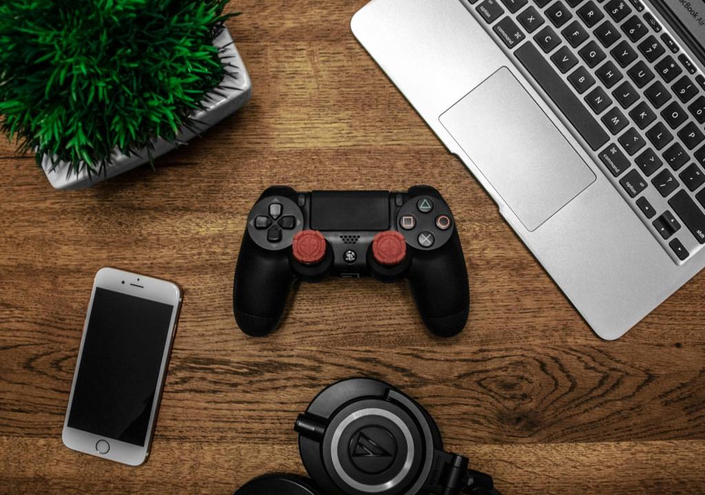 Playstation Controller iPhone MacBook House Plant On Wooden Table