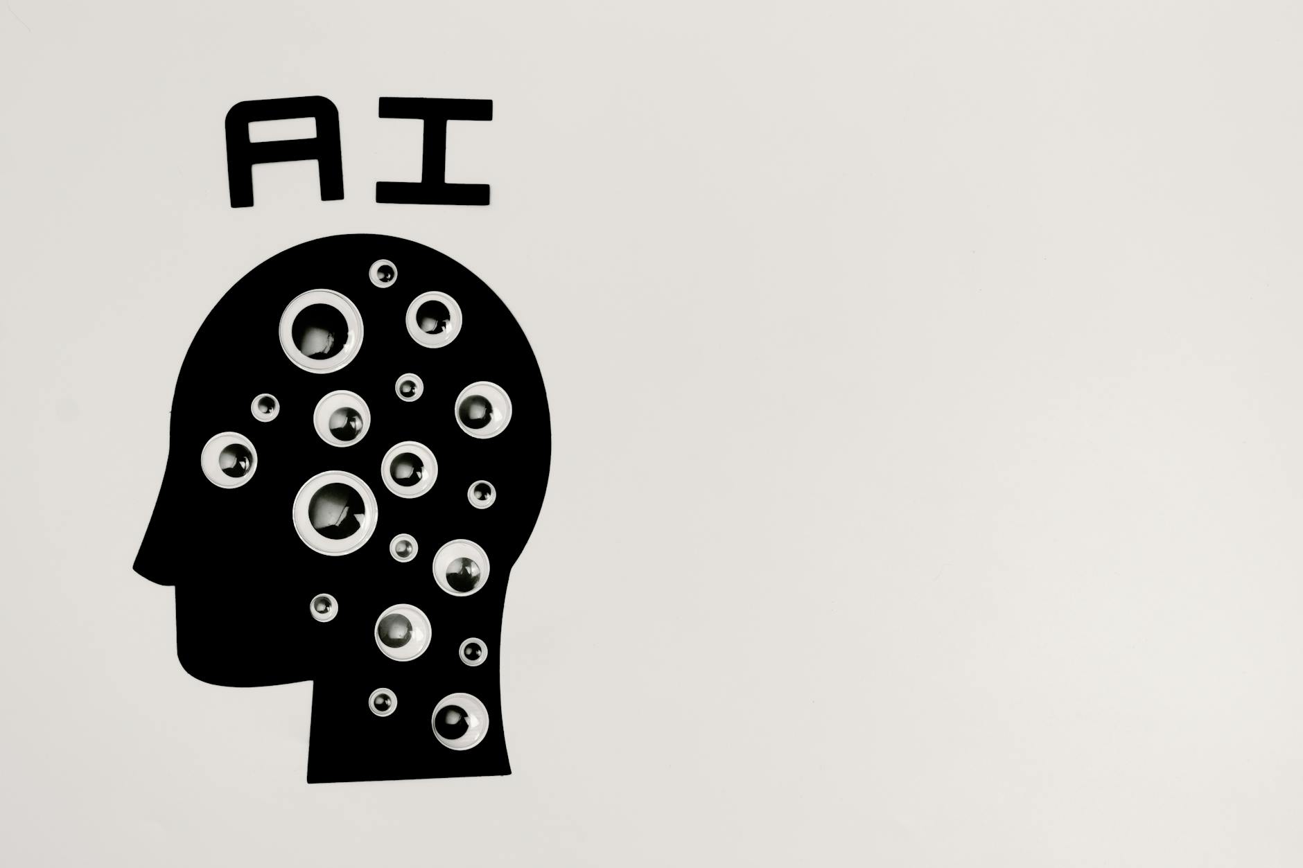 Black silhouette of head with bubbles inside and the letters AI above